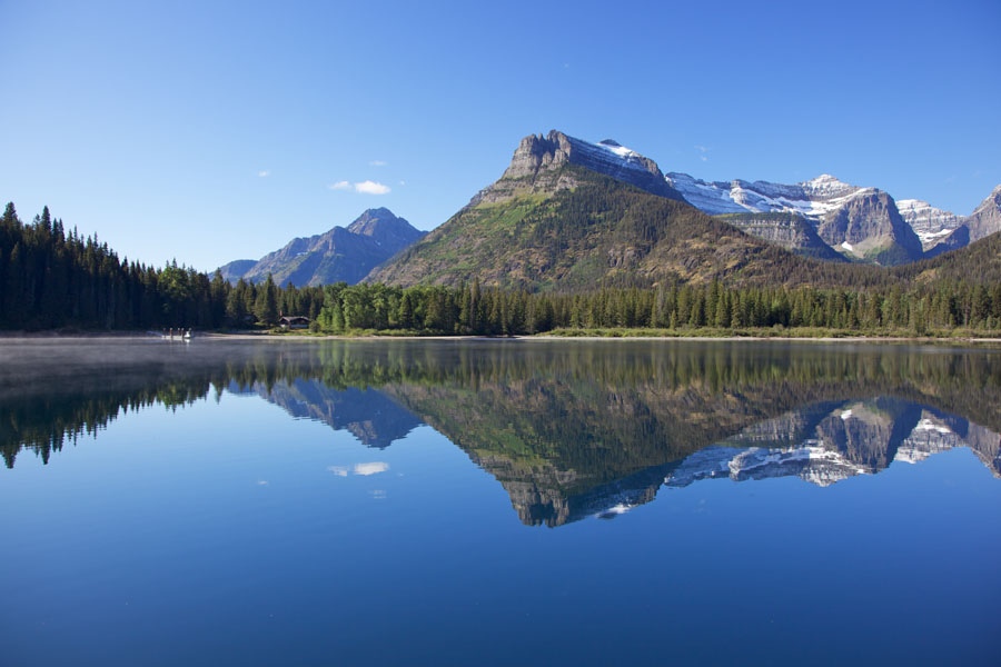 Upper Waterton Lake View over the glassy surface of Upper Waterton Lake towards Goat Haunt Ranger Station Montana / USA